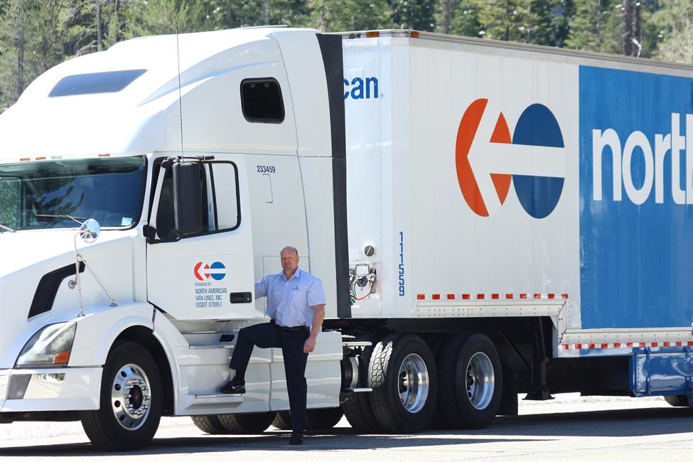 Driver standing outside of his North American truck